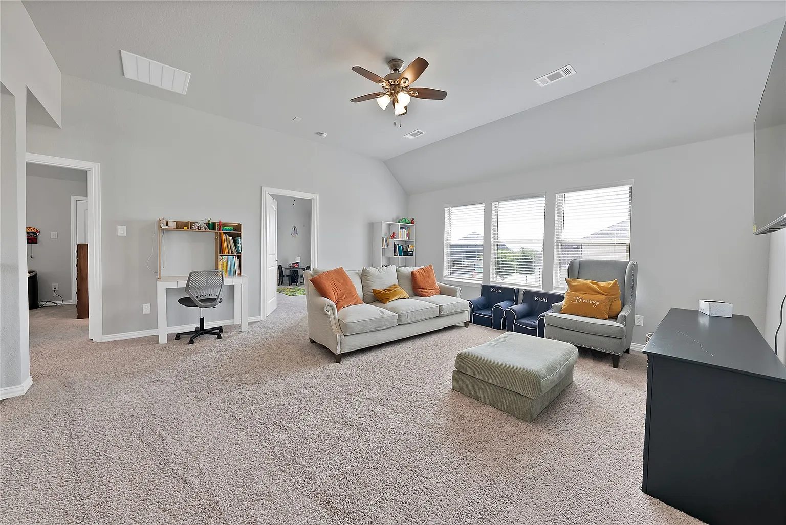 A second view of the upstairs game room and its seating areas.